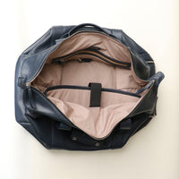 Open Interior of A navy blue leather duffle bag