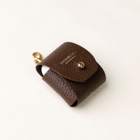 Side view of brown Airpod Case Santi Jr. leather with snap closure