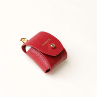 Side view of red Airpod Case Santi Jr. leather with snap closure
