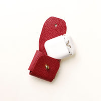 Open view of red Airpod Case Santi Jr. leather with snap closure