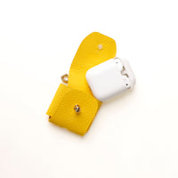 Open view of yellow Airpod Case Santi Jr. leather with snap closure