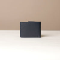 Black leather wallet on a beige background