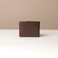 Brown leather wallet on a beige background