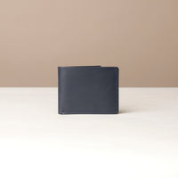 Black leather wallet on a beige background