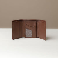 A open trifold wallet in brown color, made from pebbled leather and nappa leather slots for cards, with a long compartment for cash, displayed against a neutral background.