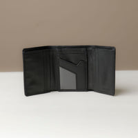 A open trifold wallet in black color, made from pebbled leather, with nappa leather slots for cards, displayed against a neutral background.