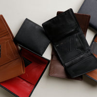 Multiple trifold wallets in a variety of colors, made with pebble and nappa leather