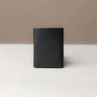 A trifold wallet in dark blue color, made from pebbled leather, displayed against a neutral background. Closed view.