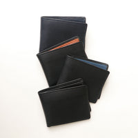 Four leather wallets of different styles on a white background