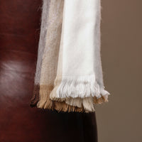 Close-up of a scarf with frayed edges on a blurred background