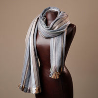 Striped scarf on a mannequin against a brown background