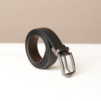 A black leather belt with a metallic buckle on a light background.