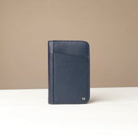 Front view of a blue Danilos Pebble leather Document Portfolio Alfaro on a beige background