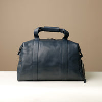 Back View of A navy blue leather duffle bag