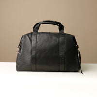Back View of a black leather duffle bag