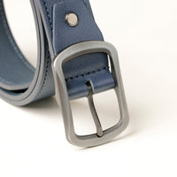 Close-up of smooth leather texture and buckle on blue belt
