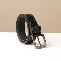 A black leather belt with a metal buckle, displayed against a neutral background.