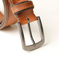 Close‑up of double stitch detail on tan leather belt