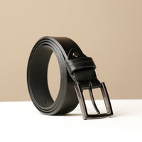 A black smooth leather belt with a metallic buckle, displayed against a neutral background.