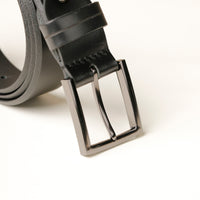 Close‑up of smooth leather texture and buckle on black belt