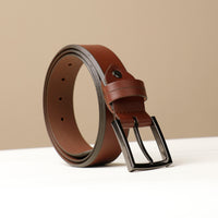 A brown smooth leather belt with a metal buckle, displayed against a neutral background.