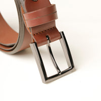 Close‑up of smooth brown leather texture and buckle detail