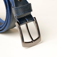 Close‑up of blue canvas texture and leather detail on belt