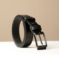A black leather belt with a metal buckle, displayed against a neutral background.