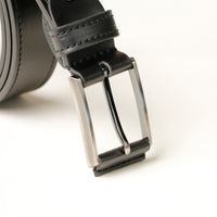 Close-up of leather buckle and textured belt detail