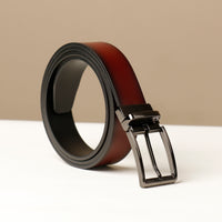 A brown gradient belt with a metallic buckle on a beige background.