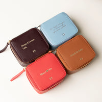 Four small leather Danilos Jewelry Organizer Anushka with embossed text on a white background