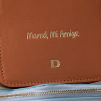 close-up view of a small leather Danilos Jewelry Organizer Anushka in brown with embossed gold Spanish text