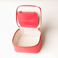 upper view of an open small leather Danilos Jewelry Organizer Anushka in red with embossed gold text on a white background