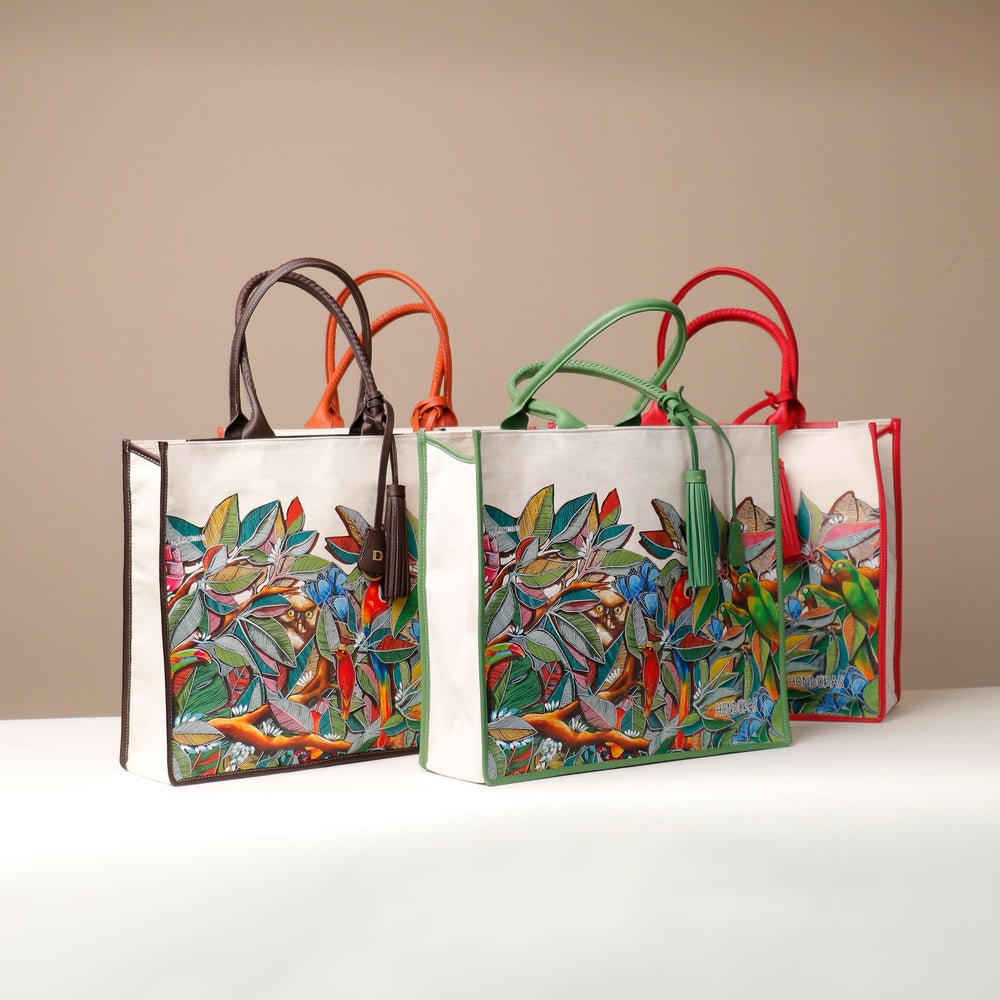 Three canvas tote bags with multicolored floral prints, displayed against a neutral background.