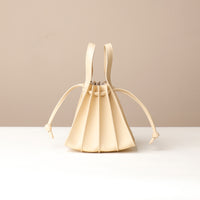 Front view of Beige Mini Papillon Bag compact leather bucket bag by Danilo’s