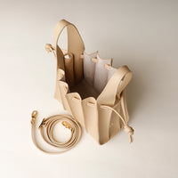 Open interior of beige Mini Papillon Bag compact leather bucket bag by Danilo’s