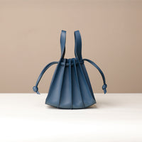 Side view of blue Mini Papillon Bag compact leather bucket bag by Danilo’s