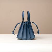 Side view of blue Mini Papillon Bag compact leather bucket bag by Danilo’s