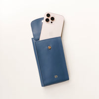 front view of a open blue danilos leather multi smartphone alessia with a phone inside a pocket over a white background