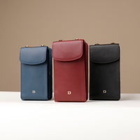 Three leather phone cases in blue, red, and black on a beige background