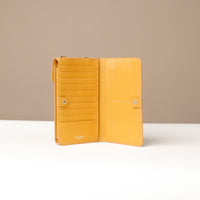 front view of a open yellow danilos leather multi smartphone alessia with 19 slots over a beige background