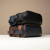 Four toiletry bags Emmiliano, one black, one blue and orange, one blue and another brown, handcrafted with premium leather