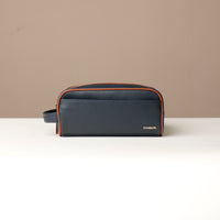 A pebble blue and tan Emmiliano toiletry bag with zipper closure, with brand Danilos, placed against a neutral background. Front view. 