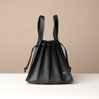 Front view of black Luxury leather bucket bag with multiple carry options