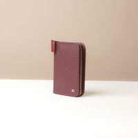 Purple wallet with a zipper on a beige background