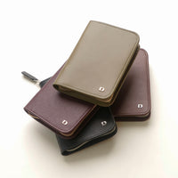 Stack of leather wallets in different colors on a white background