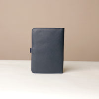 Back view of a marine blue Danilos pebble leather inkspirator on a beige background