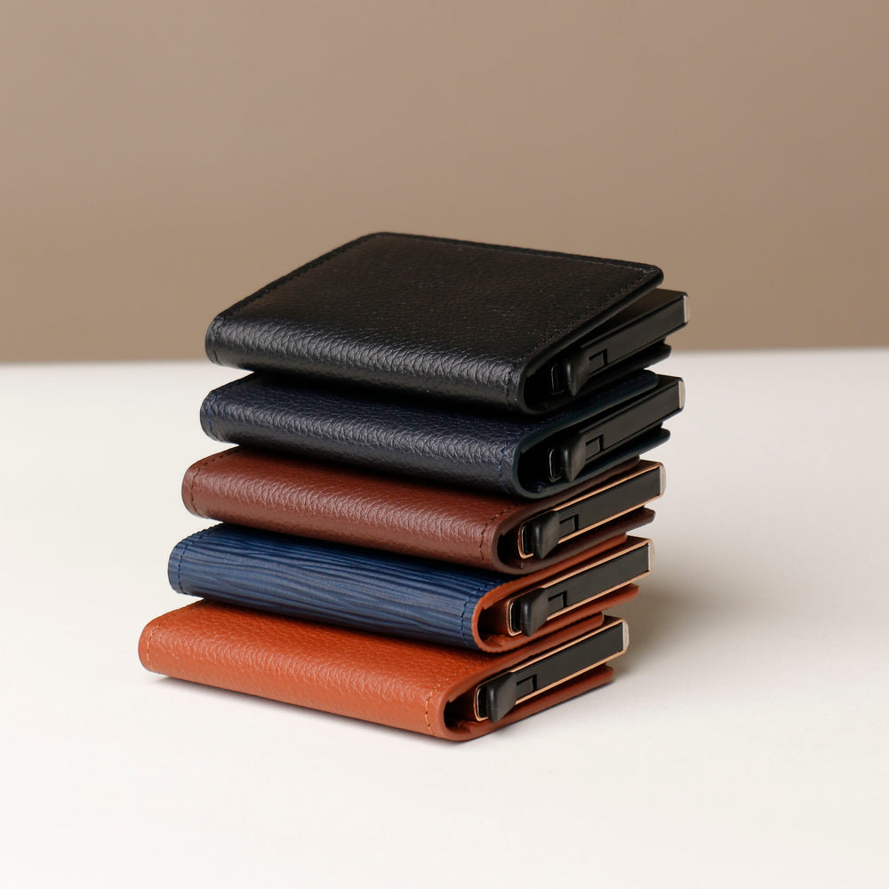 A stack of RFID blocking card case wallets in various colors including black, navy, brown, and tan.