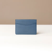 Blue cardholder on a beige background