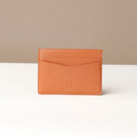 A tan-colored Patrick Card Holder made of premium leather, displayed against a neutral background.